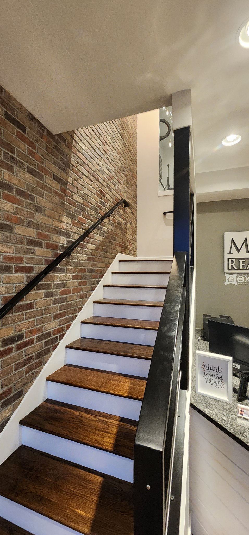 Interior stairwell with a brick feature wall