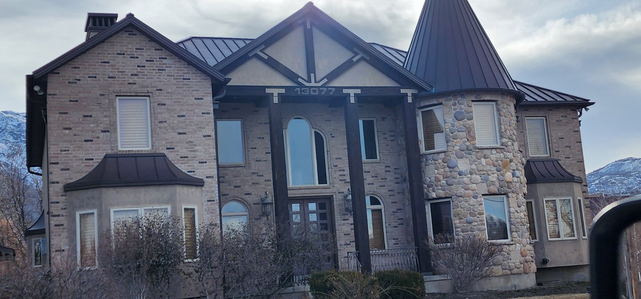 Home exterior combining brick and stone masonry