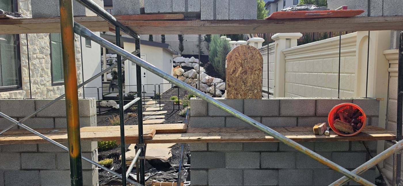 During: block wall going up around the arched window