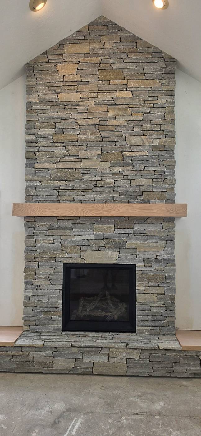 After: stacked-stone fireplace with wood mantel