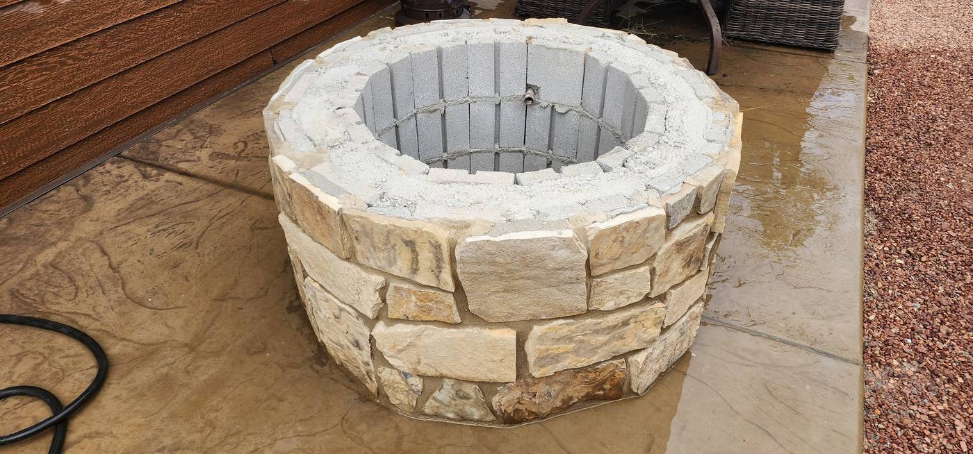 During: round fire pit, stone veneer going on