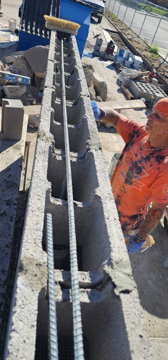 Block wall: setting block over rebar