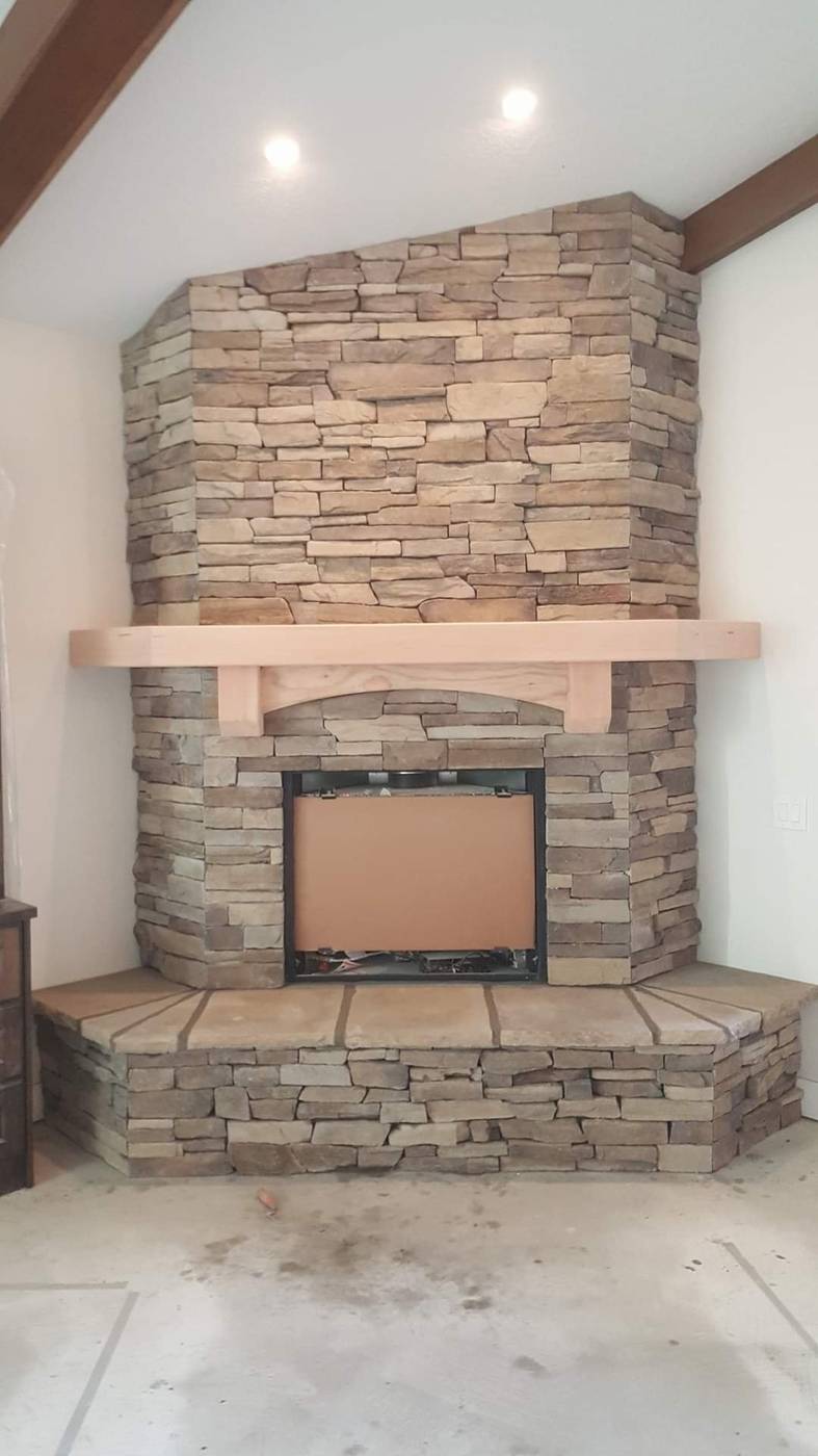 Stacked-stone fireplace with wood mantel