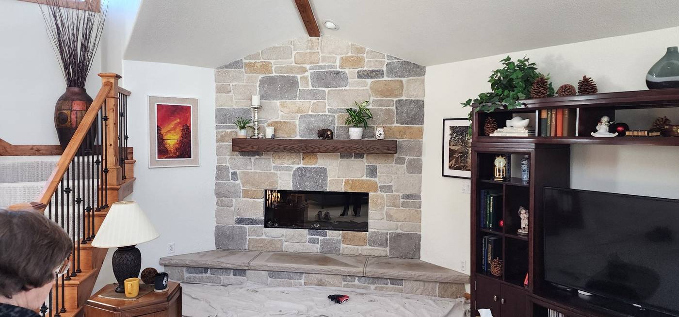 Stacked-stone fireplace with wood mantel