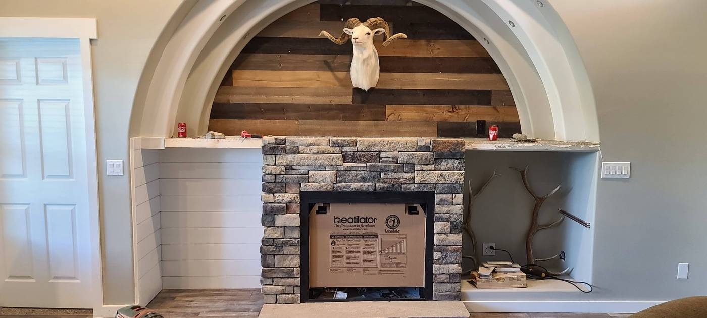 Stone fireplace with wood stove insert