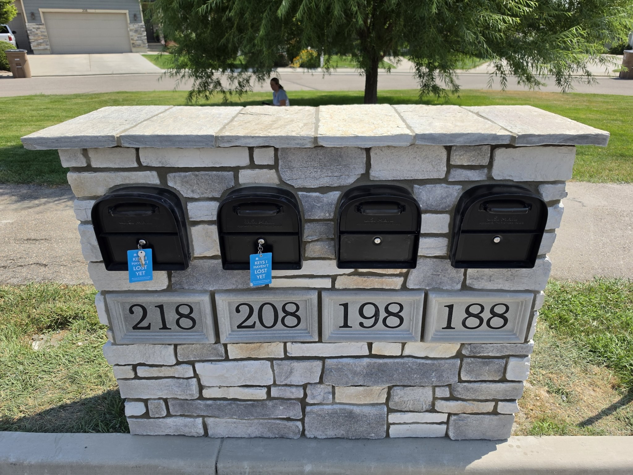 Stone mailbox cluster with multiple inset mailboxes